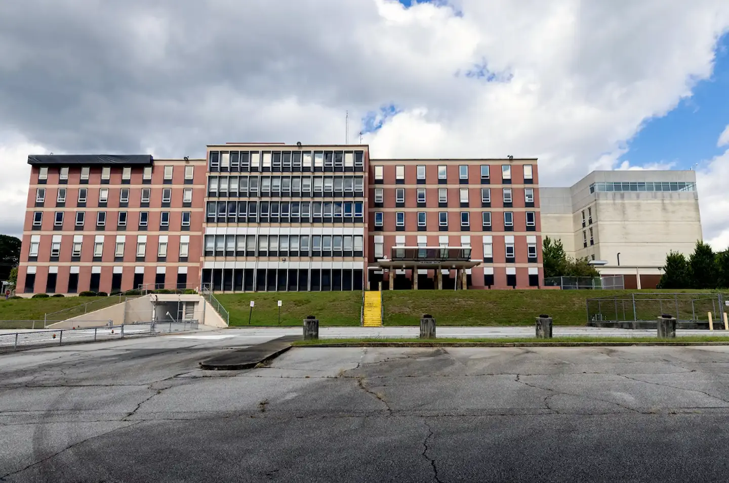 A row of buildings with a parking lot in front.
